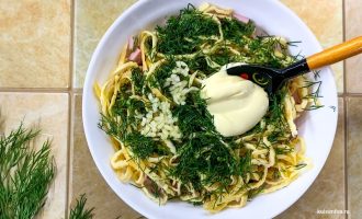 Ингредиенты салата с добавленным майонезом в глубокой миске.